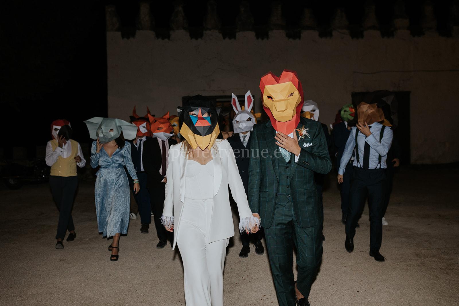 Guests camouflaged under animal heads / Photo via Silvia Sánchez Photography
