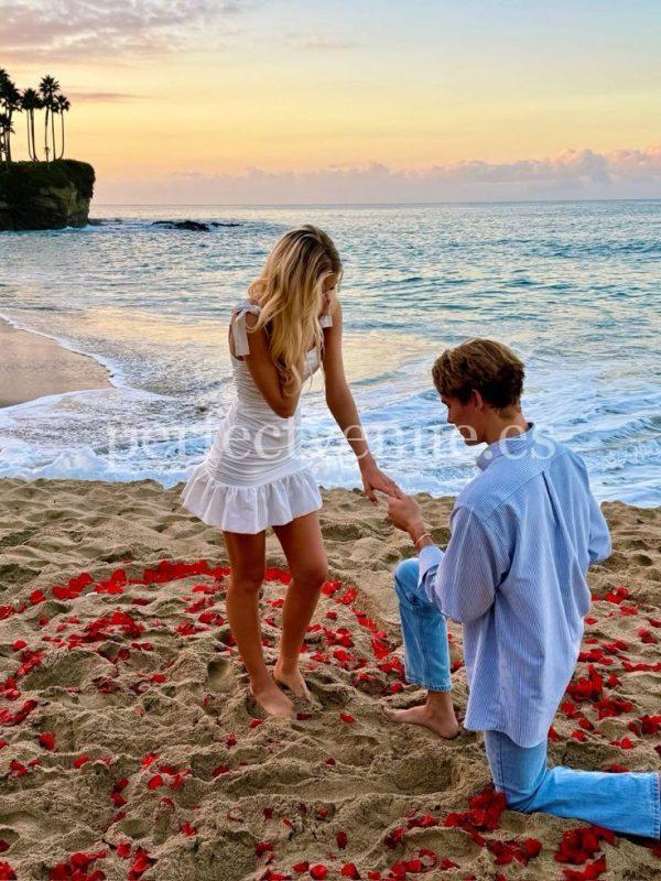 A marriage proposal in Cadiz with a rose petal heart on the beach