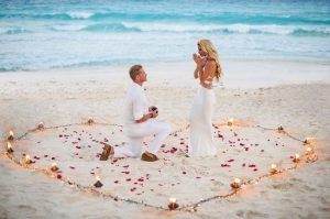 A marriage proposal in Cadiz with a rose petal heart on the beach