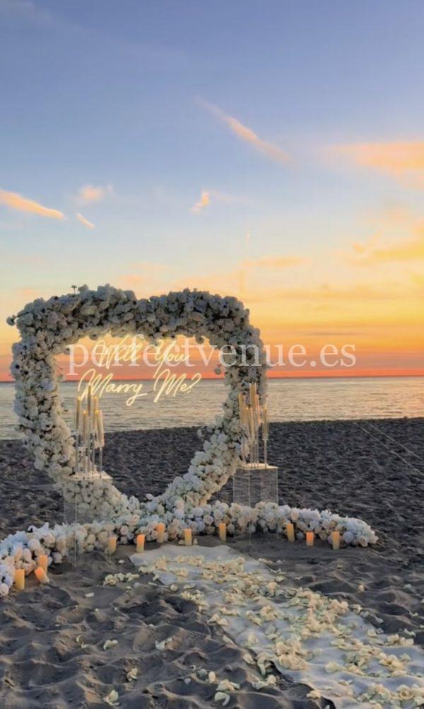 A marriage proposal in Malaga with a giant flower heart on the beach
