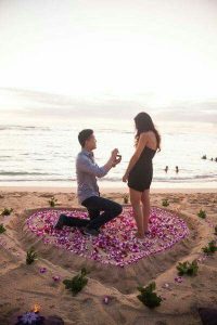A marriage proposal in Marbella with a heart of rose petals on the beach
