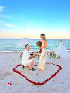 A marriage proposal in Marbella with a heart of rose petals on the beach