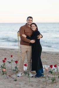 Beach proposal with roses and "Marry Me" lettering / Photo via Natalia Ortiz Events