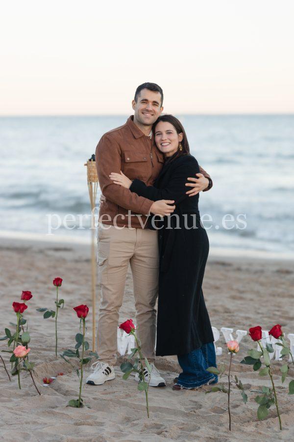 Beach proposal with roses and "Marry Me" lettering / Photo via Natalia Ortiz Events