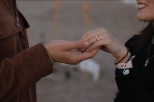 Beach proposal with roses and "Marry Me" lettering / Photo via Natalia Ortiz Events